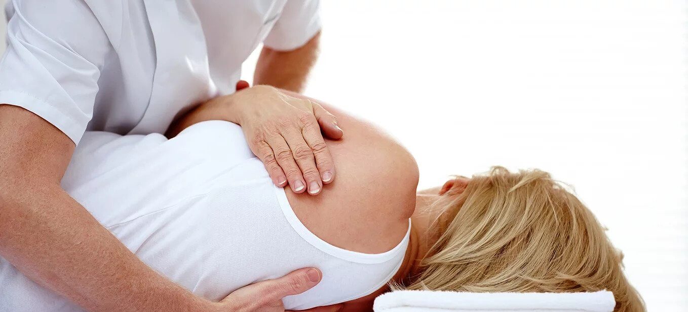 Chiropractor adjusting a patient at DOCS Medical Group in Connecticut