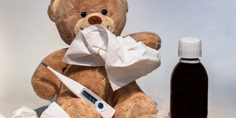 teddybear holding thermometer and tissues