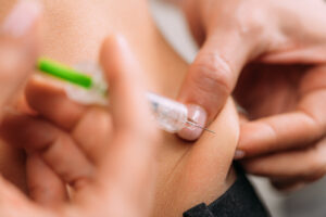 person self-administering a medical weight loss clinic semaglutide injection