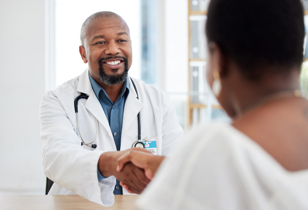 African american doctor greeting a patient at the best primary care in branford