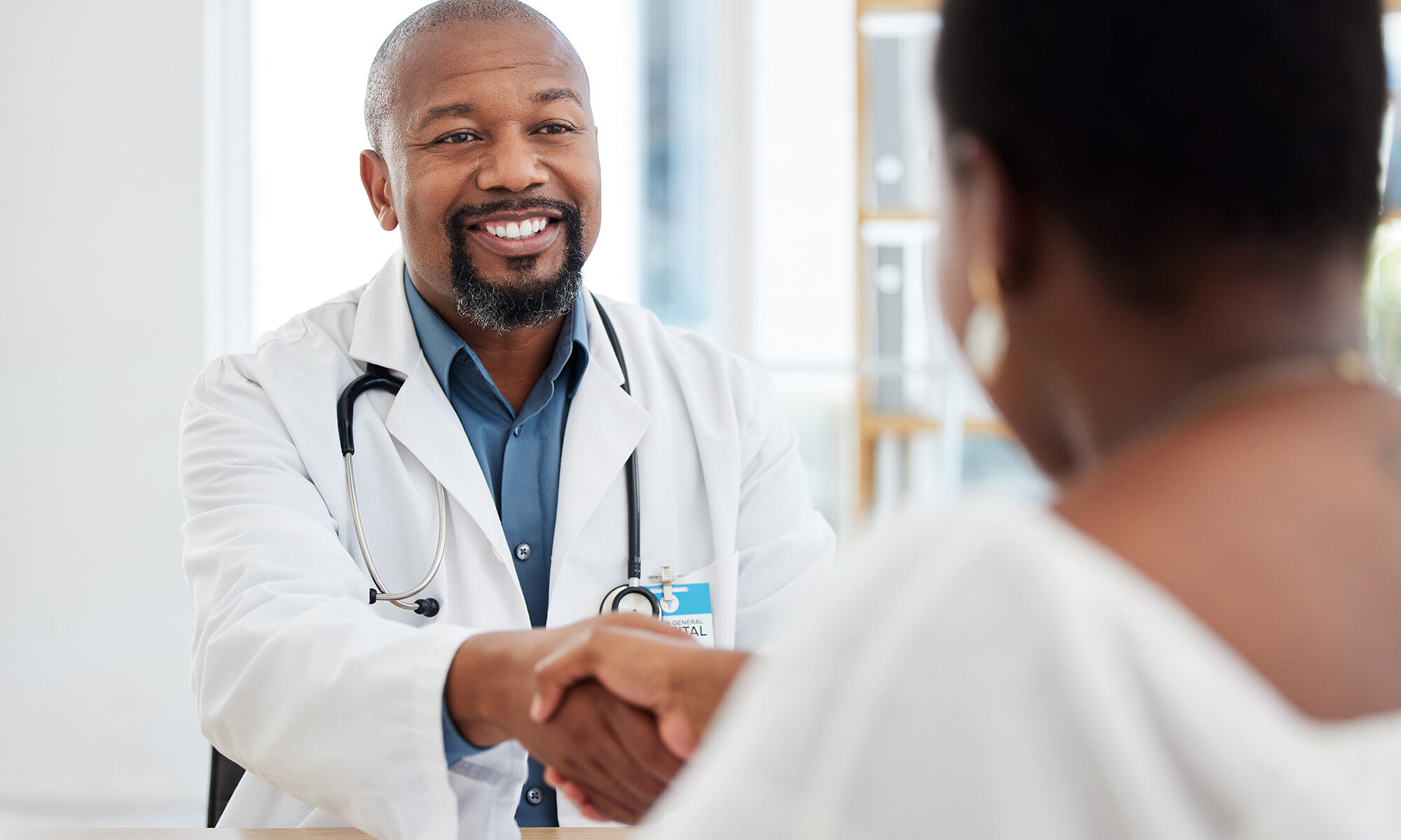 African american doctor greeting a patient at the best primary care in branford