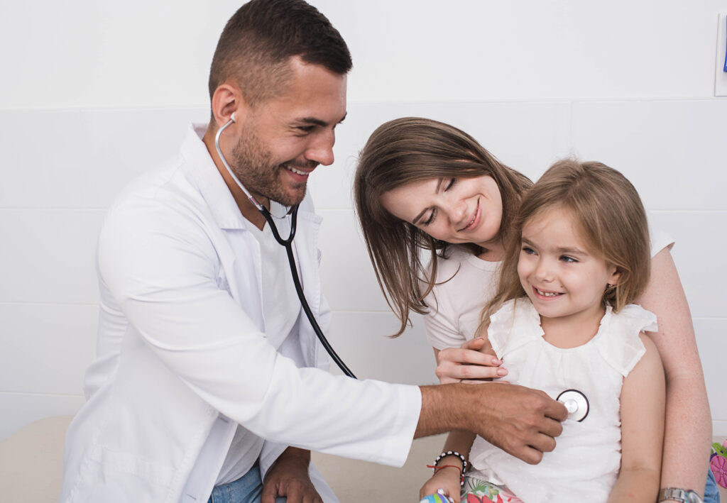 best urgent care in orange ct doctor examines a child’s heartbeat in the lap of her mother.