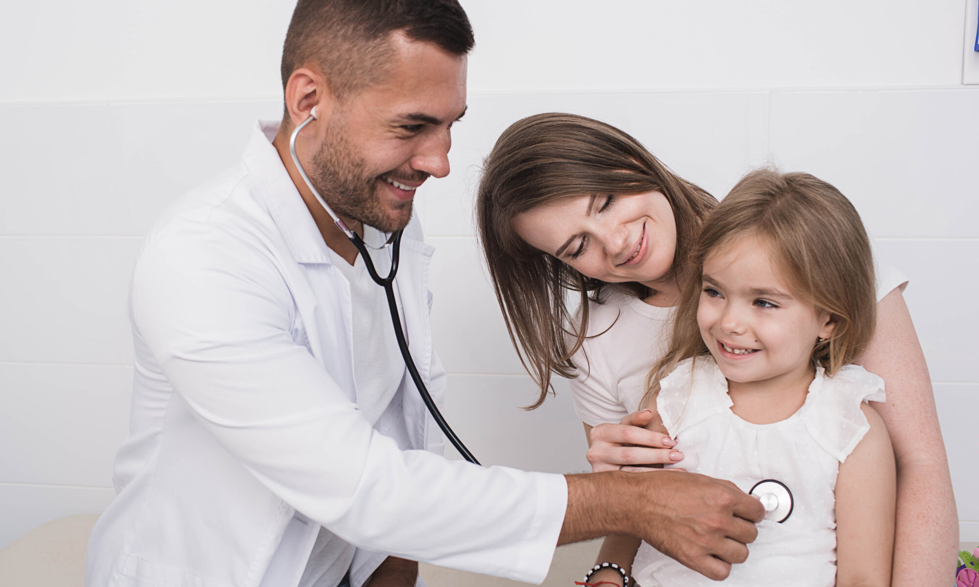best urgent care in orange ct doctor examines a child’s heartbeat in the lap of her mother.